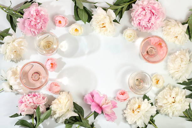 istock Floral composition with different varieties of rose wine, summer alcoholic cocktail for a party and peony flowers on a light background, the concept of a bar, cafe, 1511330862