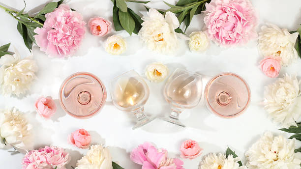 istock Floral composition with different varieties of rose wine, summer alcoholic cocktail for a party and peony flowers on a light background, the concept of a bar, cafe, 1511330863