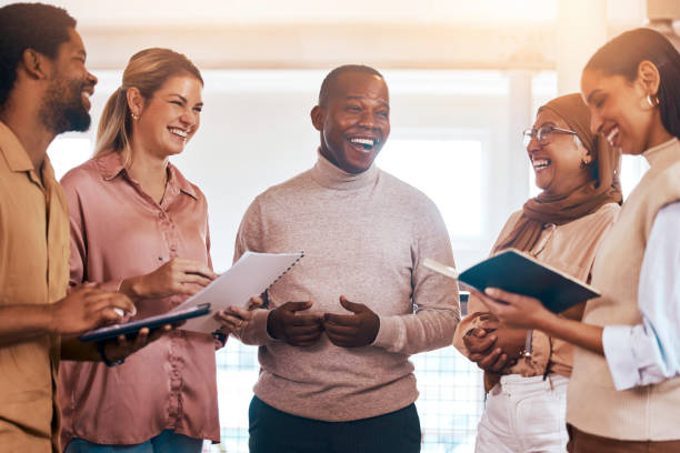 istock Laughing business people, meeting and documents in collaboration for planning, teamwork or training in office. Group of diverse employees in team brainstorming, discussion or sharing startup ideas 1511332357