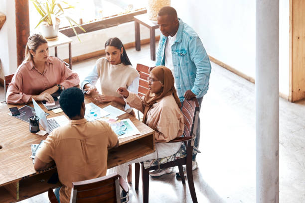 Creative business people, meeting and collaboration for graphic design, planning or teamwork for project at office. Group of employee designers in team brainstorming, strategy or ideas for startup