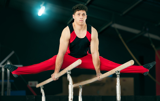 Fitness, gymnastics and man stretching, concentration and training for wellness, healthy lifestyle and sports. Male, gymnast and athlete stretch, focus or practice for balance, performance or workout