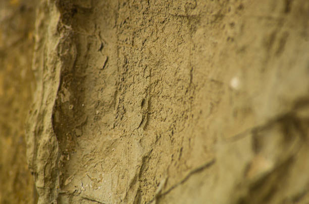 Surface of a partially broken stone wall closeup