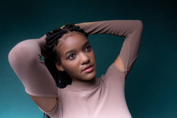 istock Young woman with braids, serious. 1511358906