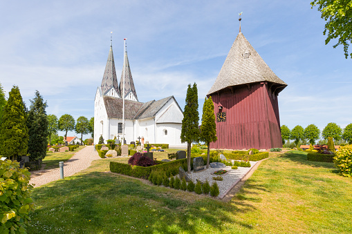 Church, old wooden bell tower and cemeery at Broager, enmark