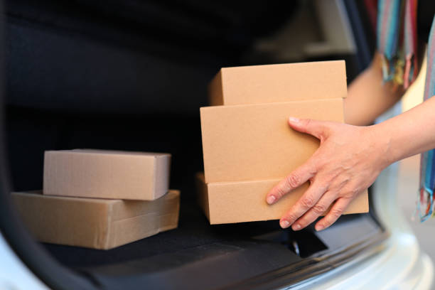 istock Close-up, hands put boxes in the trunk of a car. 1511382305
