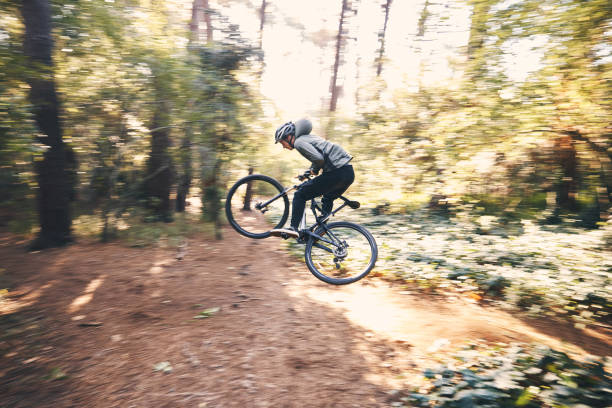 istock Cycling, speed and man on a bicycle on a forest road doing training and exercise on a bike. Fast, outdoor trail and athlete on a drive with energy on a nature adventure with fitness on a path 1511390119
