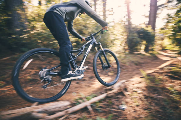 istock Cycling, speed and man on a bicycle on a dirt forest road doing training and exercise on a bike. Fast, outdoor trail and athlete with cycle and energy on a nature adventure with fitness on a path 1511390155