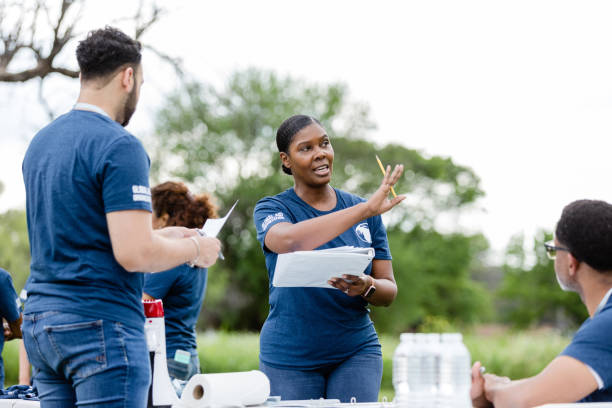 istock Female team leader gestures while explaining where things should be set up for the volunteer event 1511406714