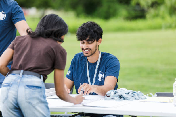 istock Unrecognizeable female volunteer writes her name on the sign sheet 1511406755
