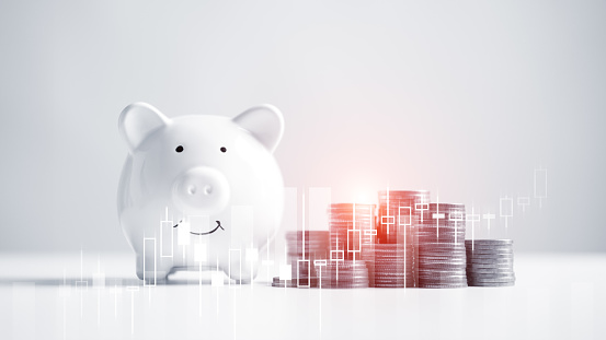 Piggy bank with money coin on white table desk background. Financial economic and money savings wealth concept. Business finance and retirement pension theme. Rich banking successful earning income