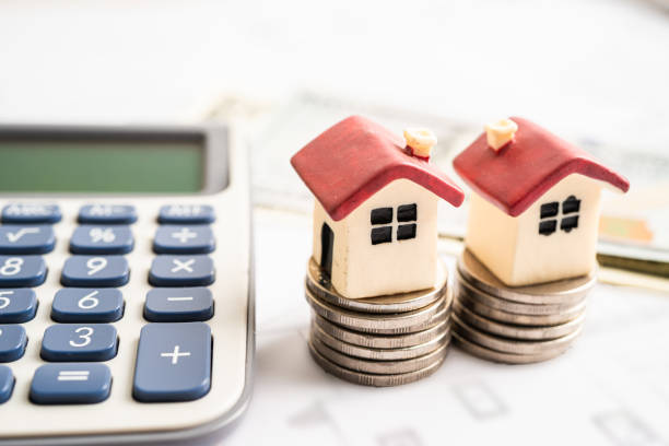 istock House on stack coins with calculator, mortgage home loan finance concept. 1511410539