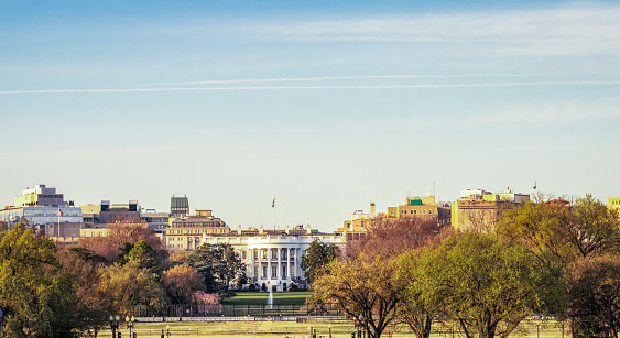A view of The White House in the distance, with a skyline including the surrounding buildings in central Washington DC.