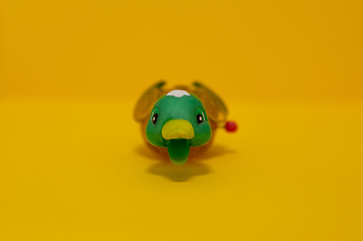 Duck toy on yellow background