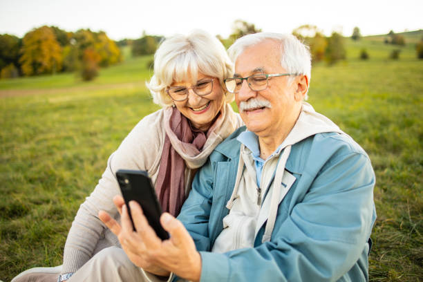 istock Senior couple using mobile phone at the nature 1511450570