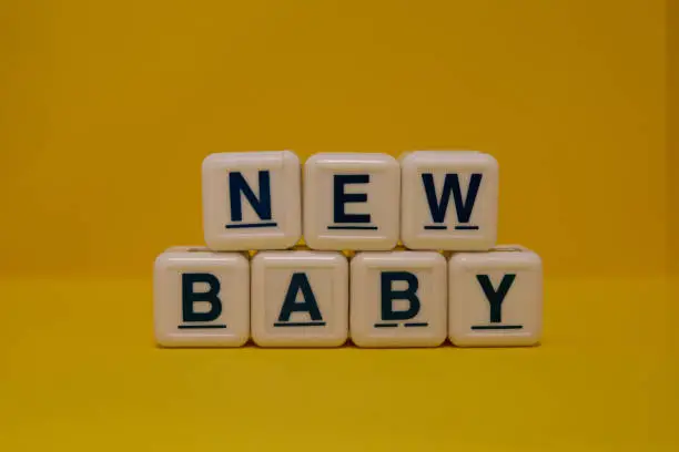 New baby letter blocks on yellow background