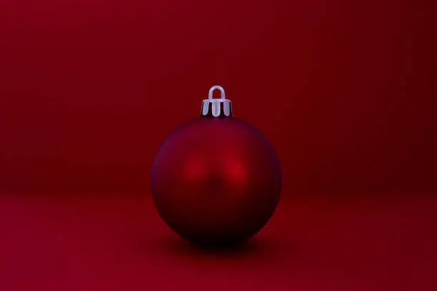 Red Christmas ball ornament on red background