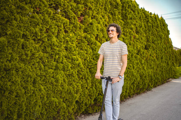 istock Man riding his electric scooter through town 1511460785