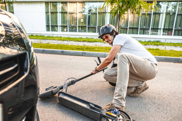 istock Man with protective helmet trying to stand up after e-scooter riding accident 1511465837