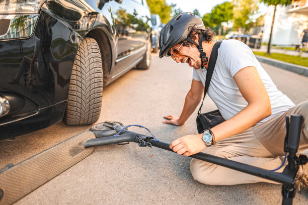 istock Man with protective helmet feeling knee pain after e-scooter riding accident 1511465909