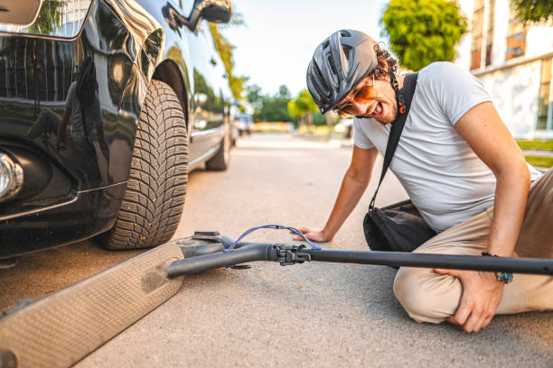 istock Man with protective helmet feeling knee pain after e-scooter riding accident 1511466455