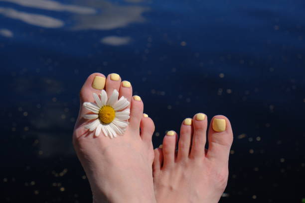 A woman's feet in orange flip-flops.
