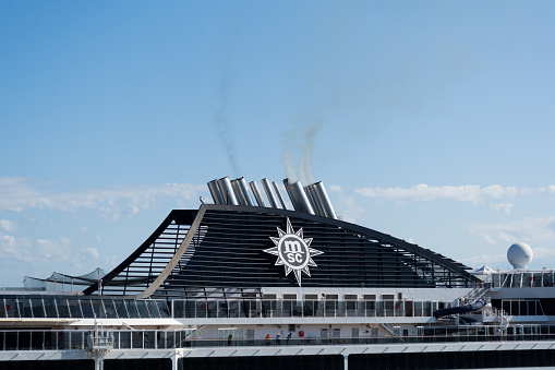 Chimney exhaust funnel stack pipe of the MSC Fantasia cruise ship with the MSC logotype emblem.