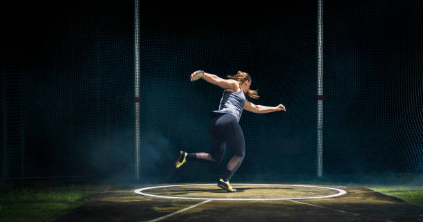 istock Female Athlete Throwing Discus 1511470456