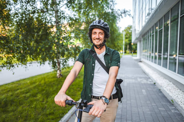 istock Portrait of a man with protective helmet riding his e-scooter to work 1511470975