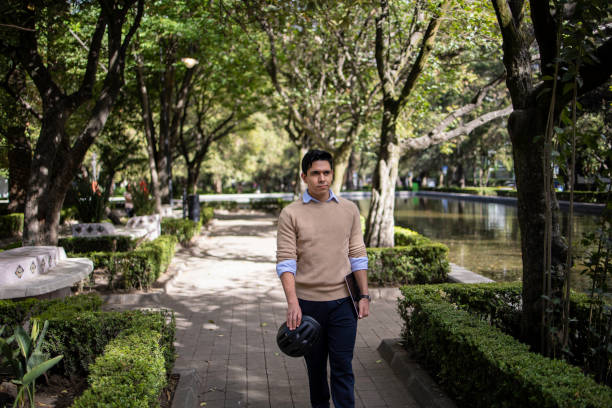 istock Young Latin man walking in the park 1511485551