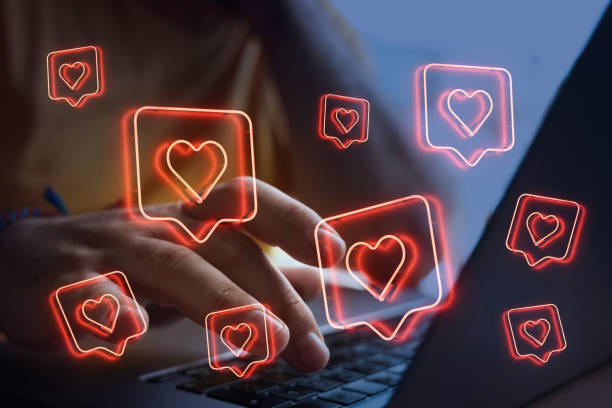 istock Social media concept. Man using laptop with heart shapes. 1511486124