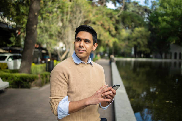 istock Portrait of young Latin man using mobile phone 1511488222
