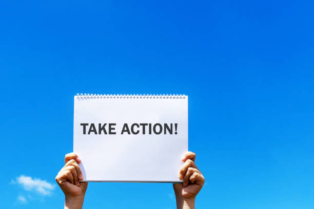 istock Hands holding a placard with text take action 1511500560
