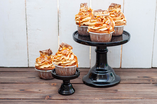 Peanut butter cupcakes with salted caramel, toffee and chocolate bites