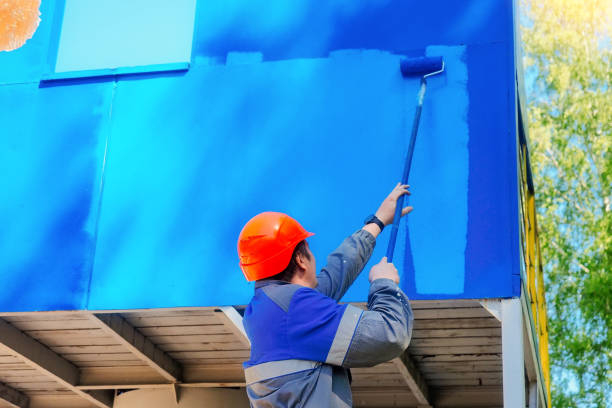 istock Industrial professional painter in hard hat and work clothes paints metal surface with roller on summer day. Authentic workflow. 1511516993