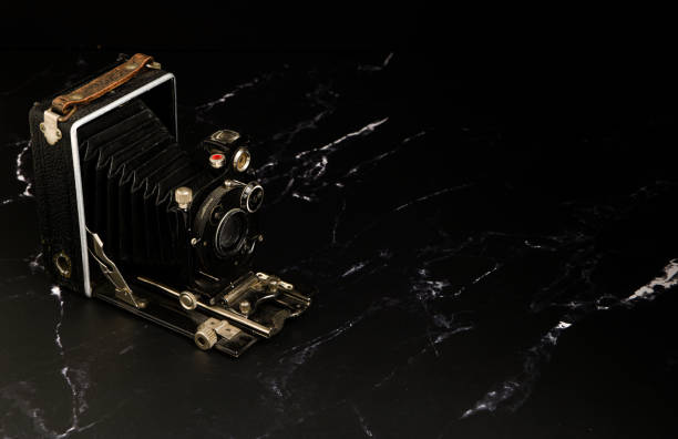 istock Old analogue camera on a black background with empty space 1511527753