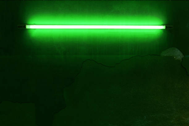 istock Green neon bulbs on old concrete wall, vintage style. 1511527763