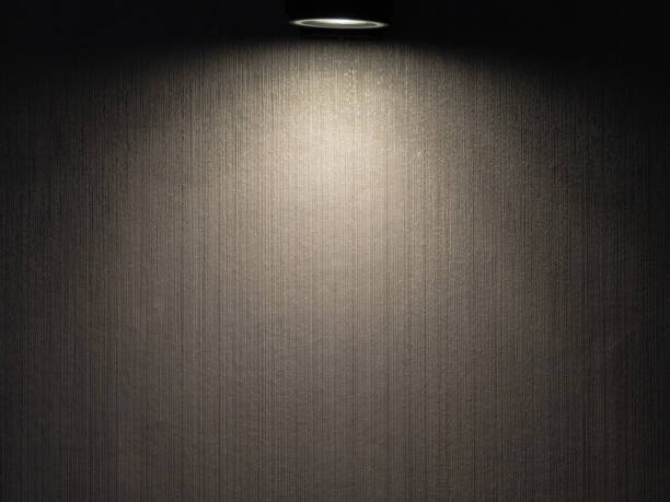istock The wall lamp, with its sleek design and soft glow, added a touch of elegance and functionality to the room. Its warm light cascaded gently across the walls,creating cozy ambiance and casting.close up 1511538780