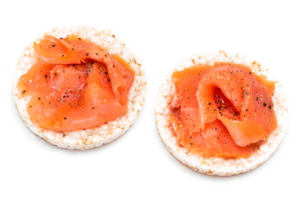 istock Rice Cake Sandwiches with Fresh Salmon Slices Isolated on White 1511548019