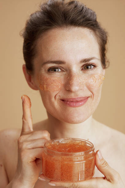 istock smiling young female with face scrub 1511561058