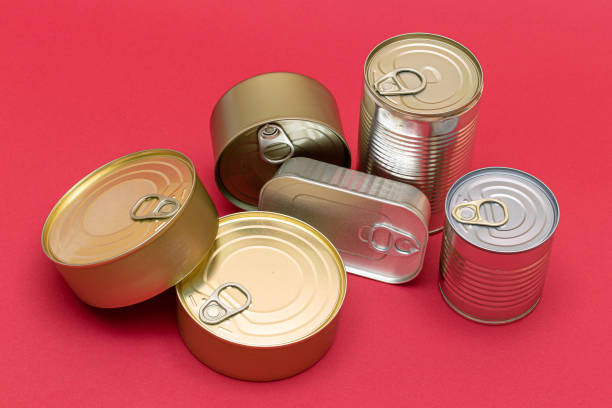 istock Unopened Tin Cans with Blank Edges on Red Background 1511566076