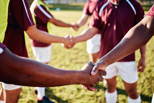 Man, sports and handshake for team introduction, greeting or sportsmanship on the grass field outdoors. Sport men shaking hands before match or game for competition, training or workout exercise