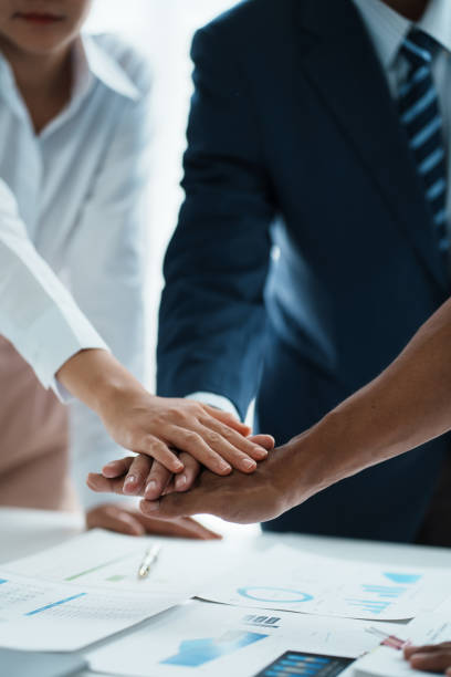 istock Young business people putting their hands together. Stack of hands. Unity and teamwork concept. 1511568799