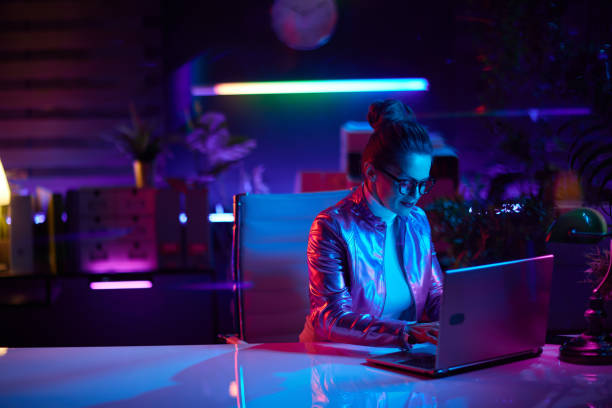 istock stylish woman in glasses using laptop in modern office 1511570446