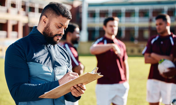 istock Fitness, rugby and coach with clipboard, teamwork and training for competition, workout and wellness. Male, trainer and group with healthy lifestyle, sports and practice for exercise, support or plan 1511595537