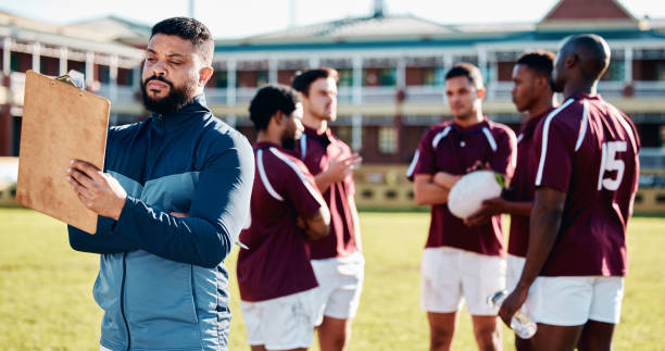 istock Coaching, rugby or man writing with a strategy, planning or training progress with a game field formation. Leadership, mission or manager with sports men or athlete group for fitness or team goals 1511595545