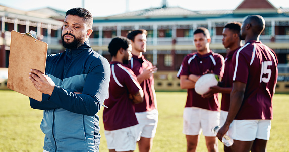 Coaching, rugby or man writing with a strategy, planning or training progress with a game field formation. Leadership, mission or manager with sports men or athlete group for fitness or team goals