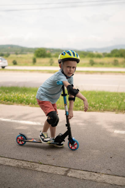 istock Little boy riding scooter. Kids ride kick board 1511606991