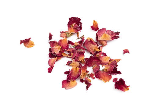 Dry rose flower petals tea on the white background