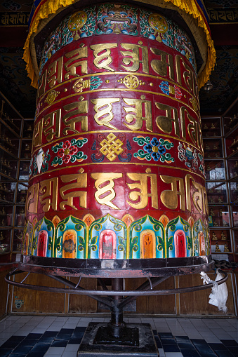 A Prayer wheel or mani wheel at Jangchub Choeling Tibetan Monastery. Located in the Tibetan Refugee Camp know as Tashi Palkhel in Hemja, Pokhara, Nepal.