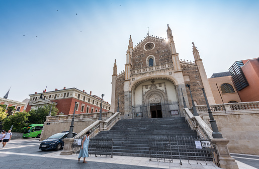Madrid, Spain - June 28, 2023: Tourists looking for spiritual relief at La Iglesia de San Jerónimo el Real (Church of San Jerónimo el Real). This Roman Catholic church, in Elizabethan Gothic style, is from the early 16th century, in the center of Madrid.